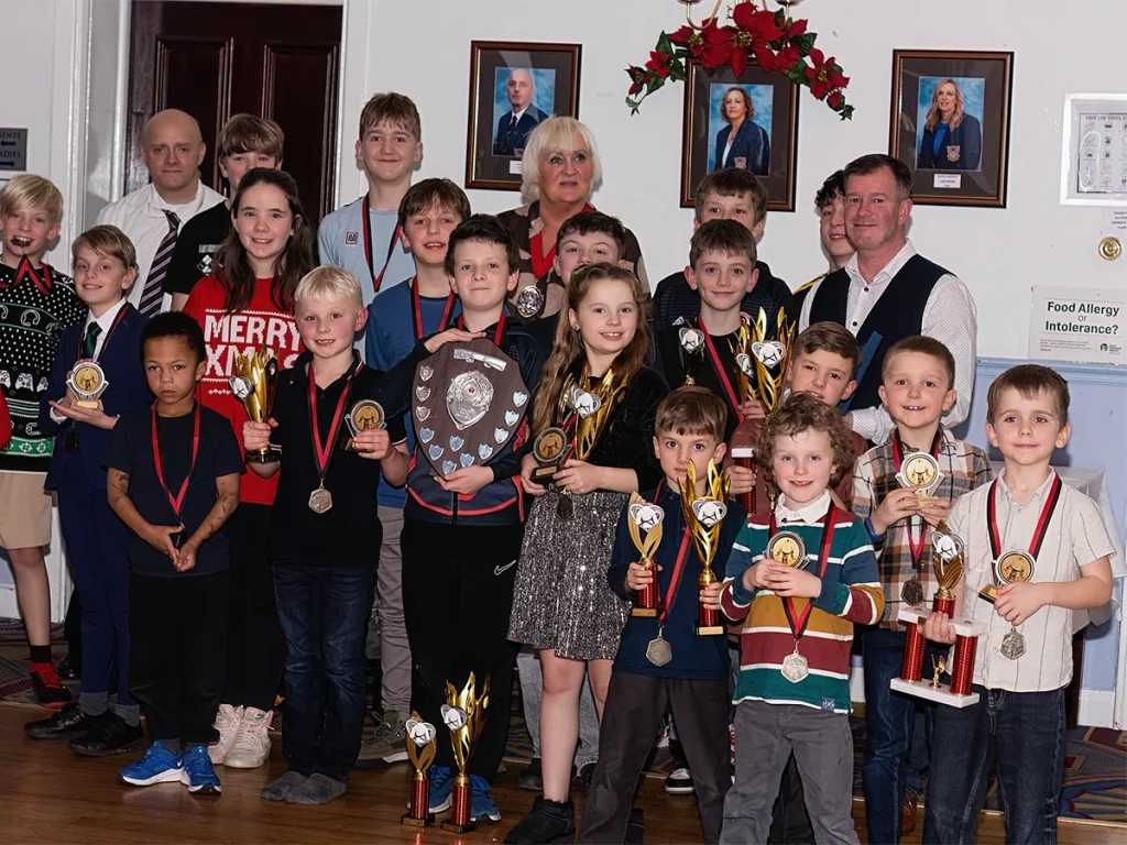 St Martins Junior Karate Club members celebrating together with medals and trophies