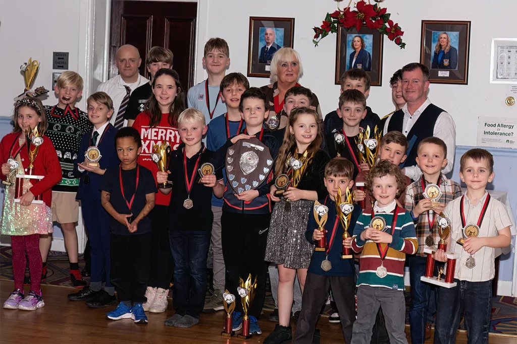 St Martins Junior Karate Club members at a club awards presentation holding trophies and medals