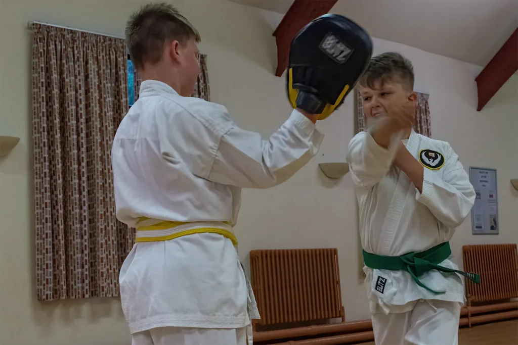 SMJKC students practising karate pad work during a class