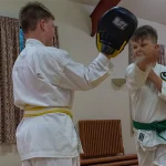 Junior karate student practising during class